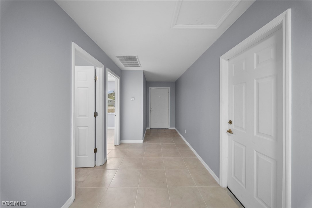 4838 29th Street Southwest Lehigh Acres, FL 33973 - Photo 3 of 25 a view of a hallway with wooden floor
