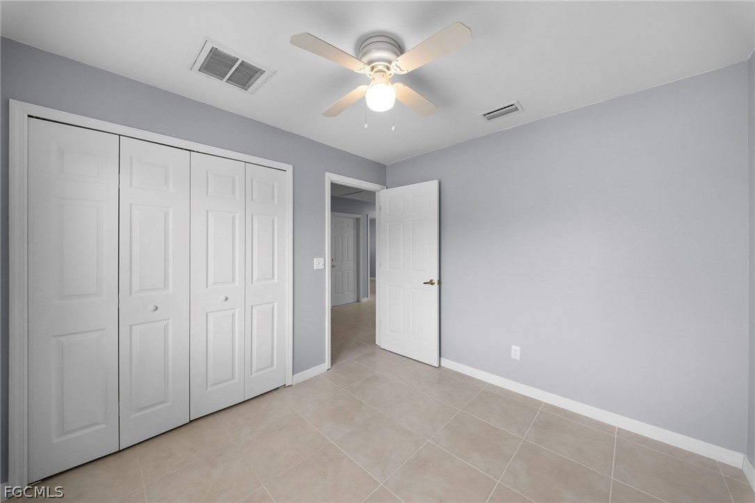 4838 29th Street Southwest Lehigh Acres, FL 33973 - Photo 6 of 25 an empty room with closet and a ceiling fan