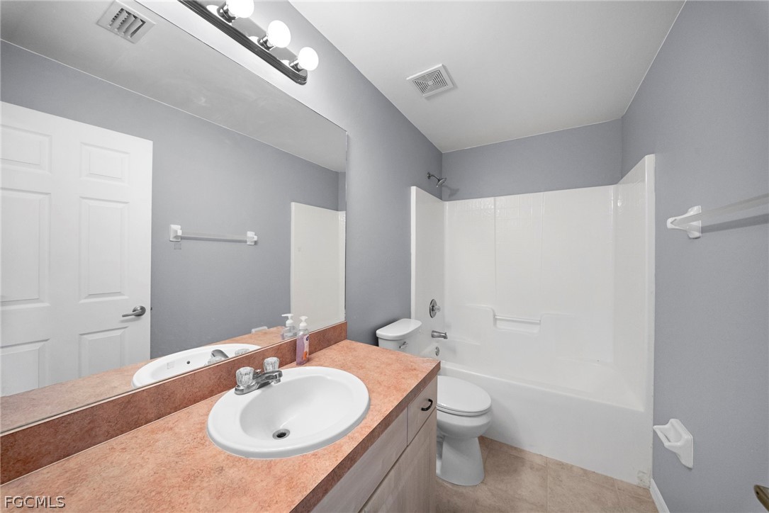 4838 29th Street Southwest Lehigh Acres, FL 33973 - Photo 7 of 25 a bathroom with a sink a toilet and shower