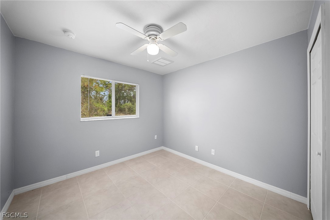 4838 29th Street Southwest Lehigh Acres, FL 33973 - Photo 8 of 25 an empty room with a window and a fan
