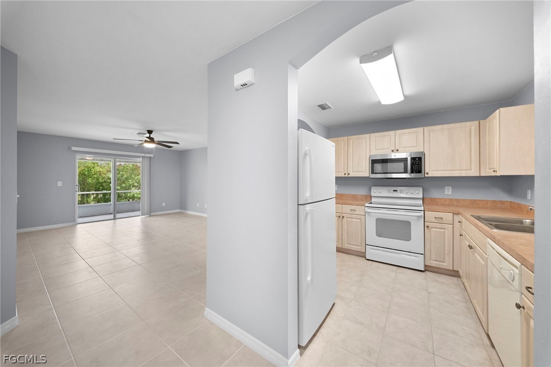 4838 29th Street Southwest Lehigh Acres, FL 33973 - Photo 10 of 25 a kitchen with granite countertop white cabinets and white appliances