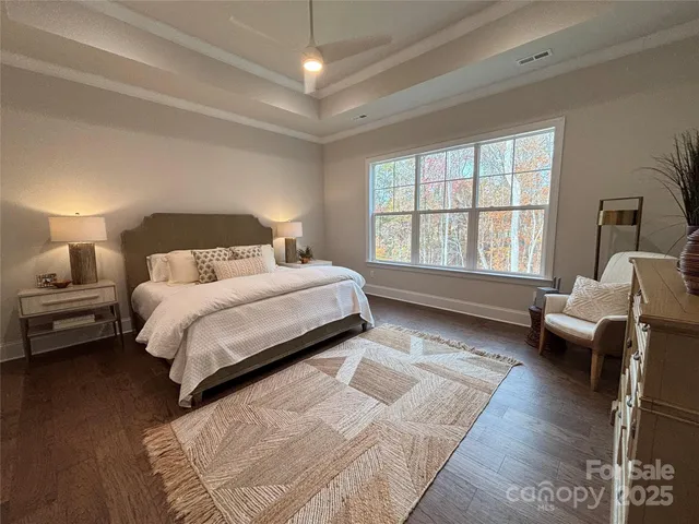 a spacious bedroom with a bed couch and a window