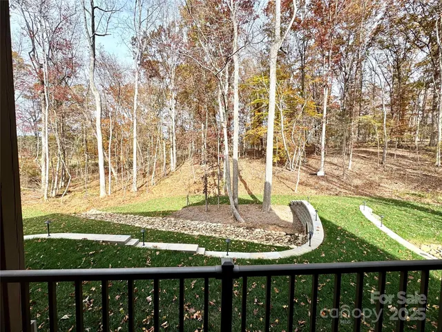 a view of a balcony with a yard