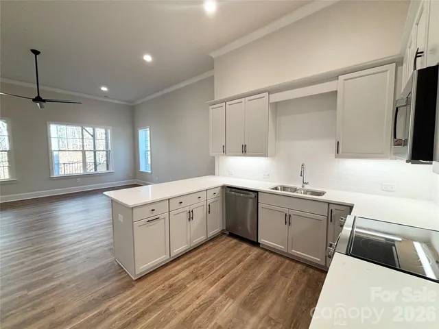 a kitchen with sink stove and cabinets