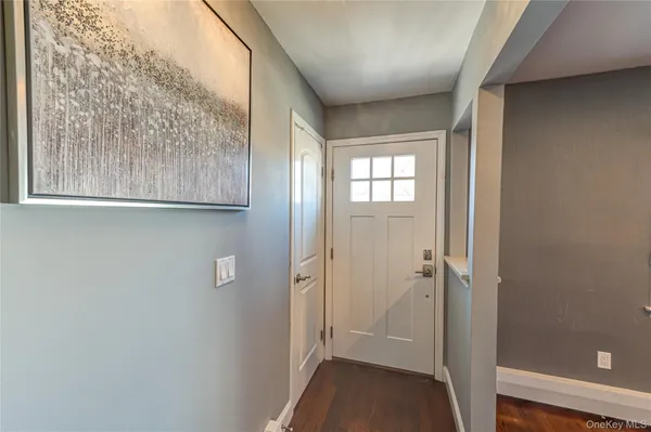a view of a room with furniture and wooden floor