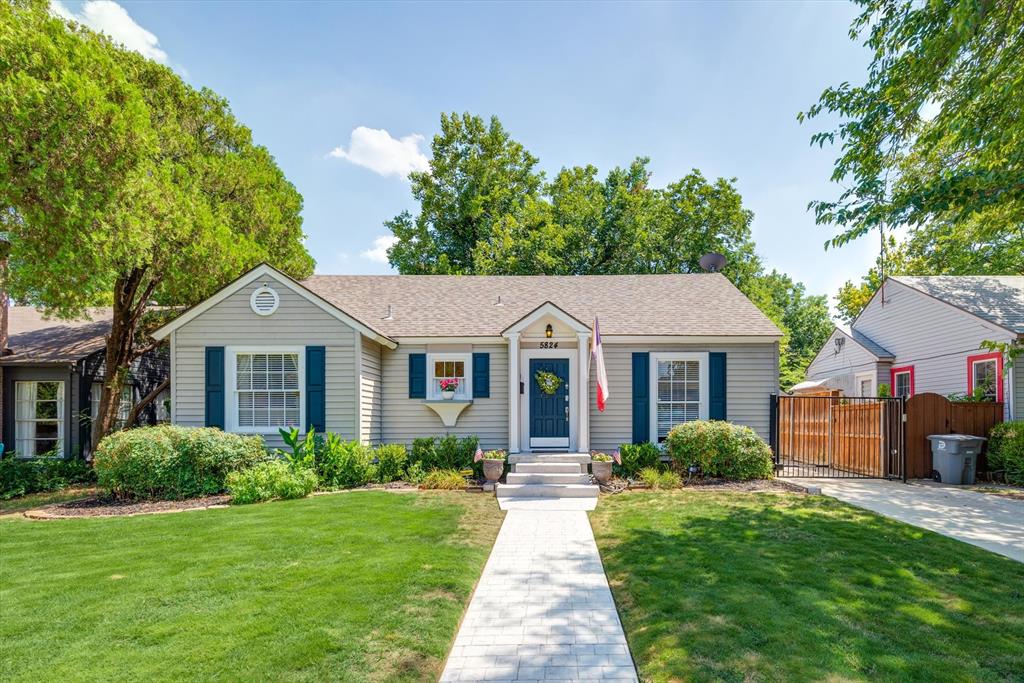 5824 Ravendale Lane Dallas, TX 75206 - Photo 1 of 1 a front view of a house with a yard and potted plants