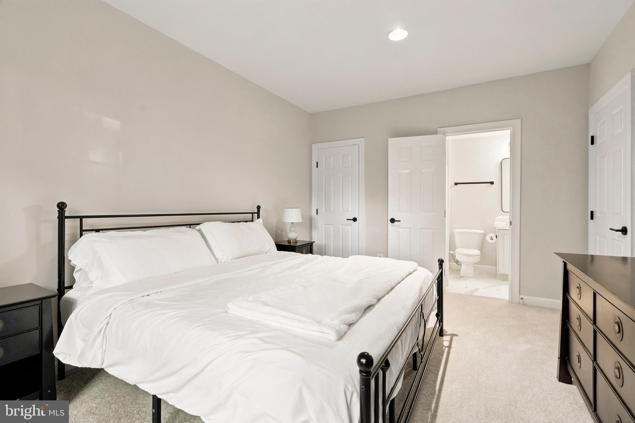 9313 Harrisons Farm Way Laytonsville, MD 20882 - Photo 58 of 77 a spacious bedroom with a bed and a walk in closet