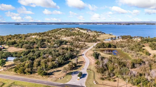 a bed with white sheets and a blanket