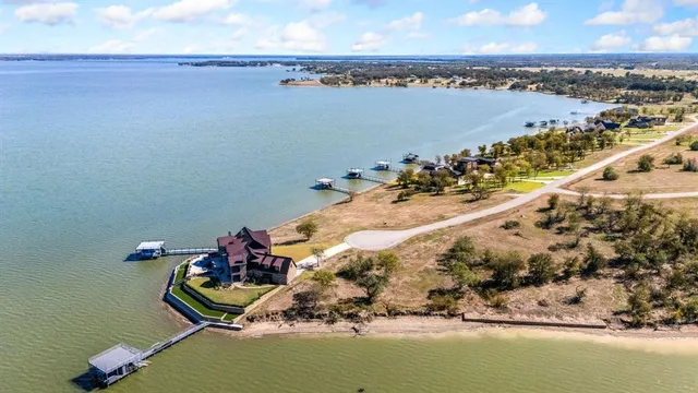 an aerial view of a house with a lake view