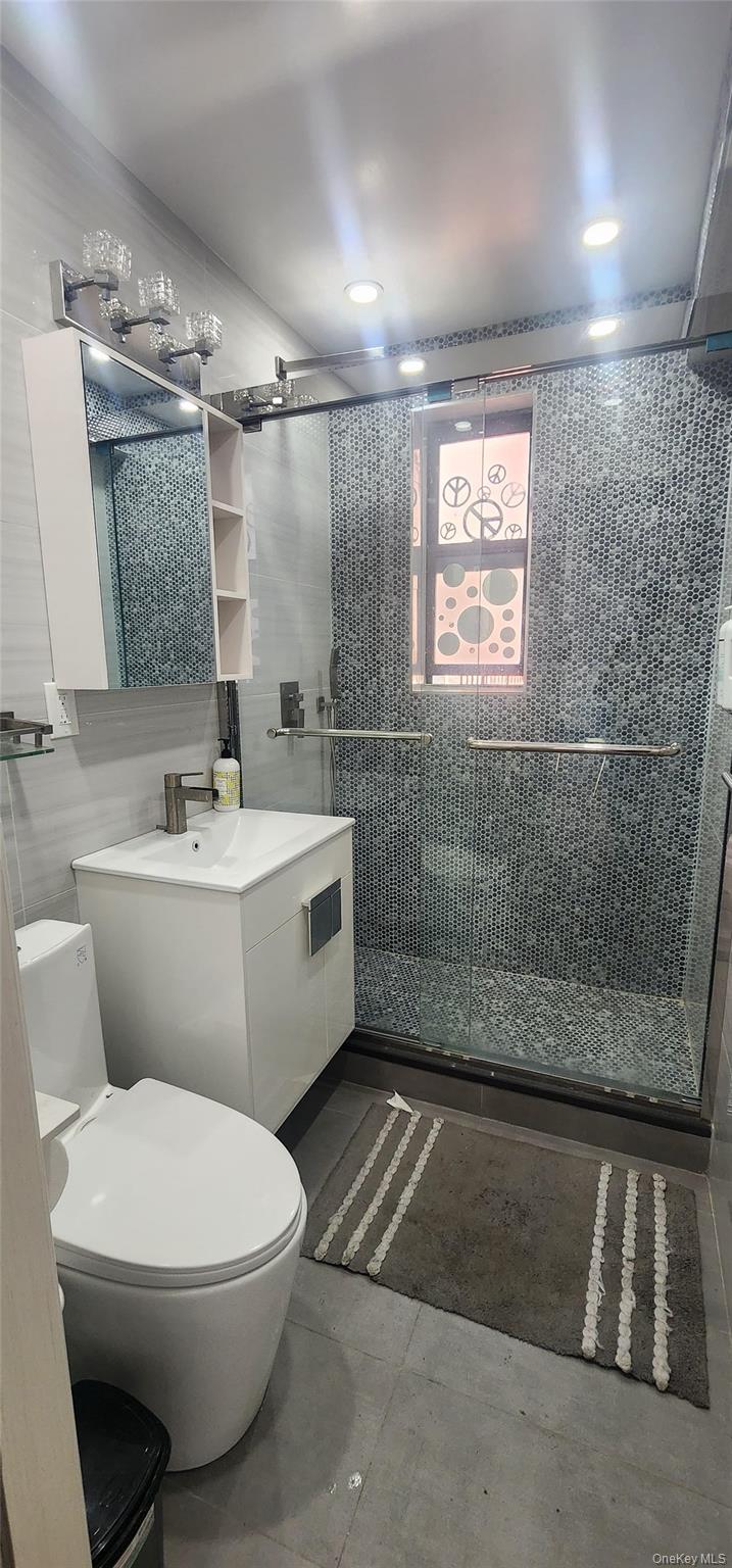 141-60 84th Road, Unit 6A Queens, NY 11435 - Photo 13 of 17 a bathroom with a sink toilet and shower