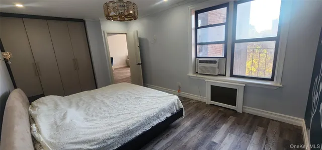 a bedroom with a bed and a television