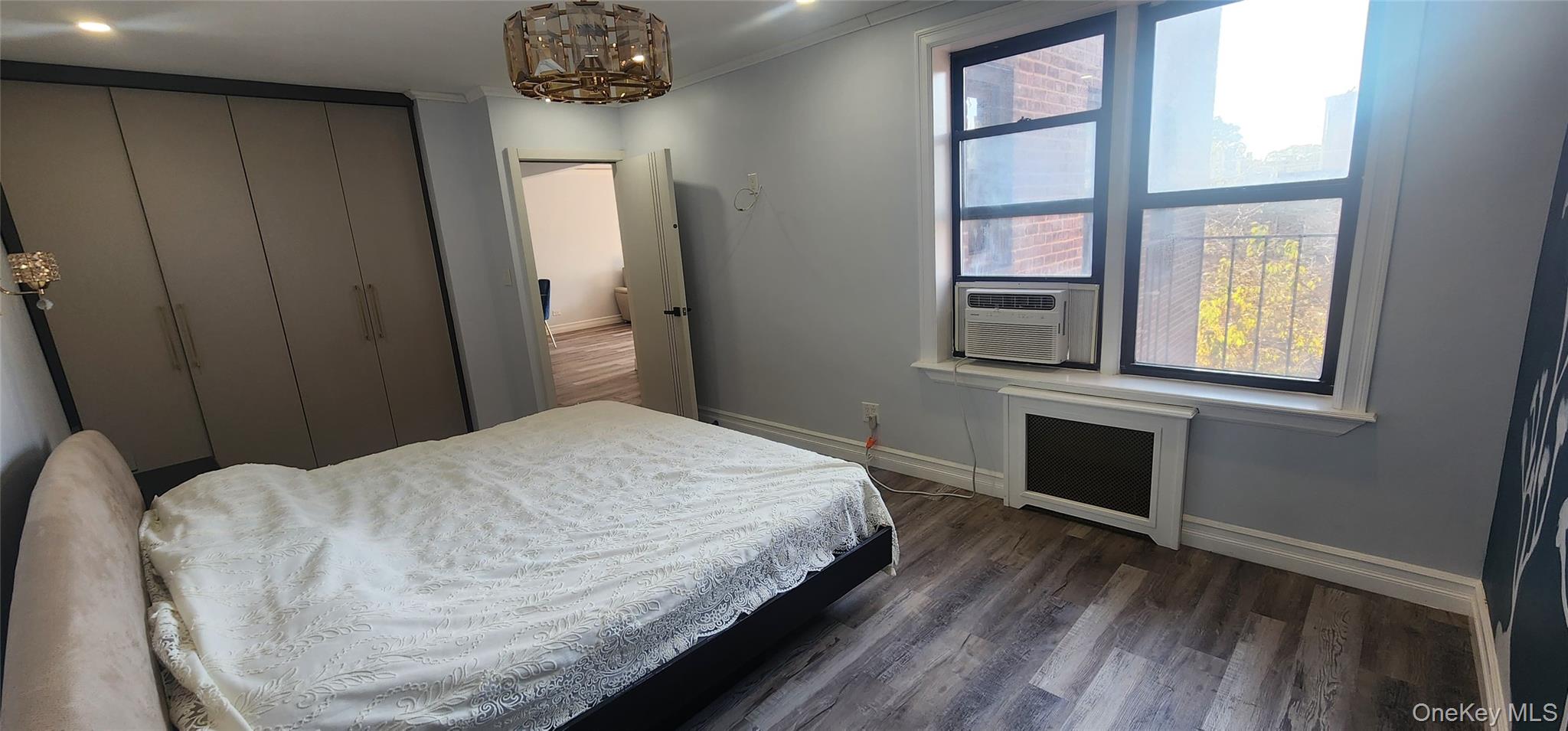 141-60 84th Road, Unit 6A Queens, NY 11435 - Photo 14 of 17 a bedroom with a bed and a television