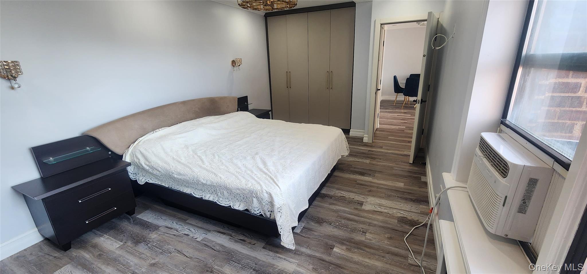 141-60 84th Road, Unit 6A Queens, NY 11435 - Photo 15 of 17 a bedroom with a bed and wooden floor