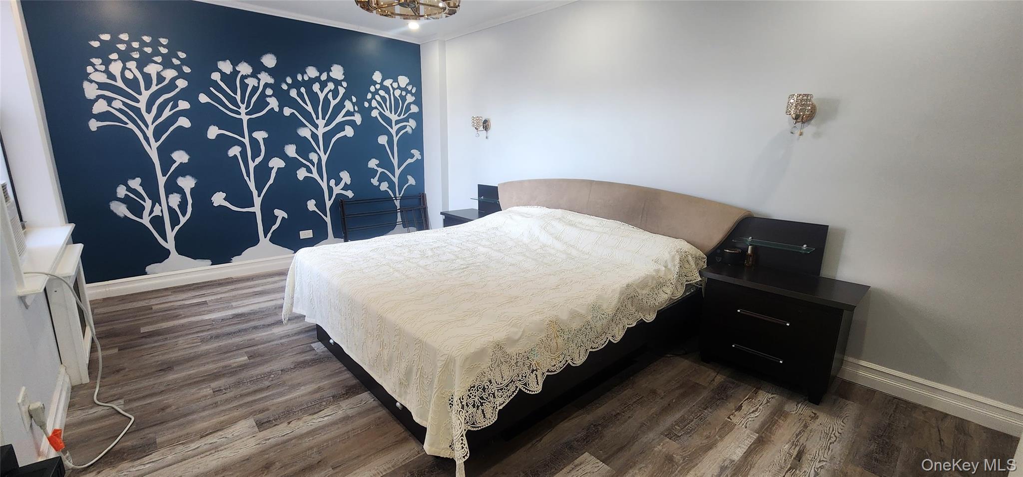 141-60 84th Road, Unit 6A Queens, NY 11435 - Photo 16 of 17 a bedroom with a bed and a painting on the wall