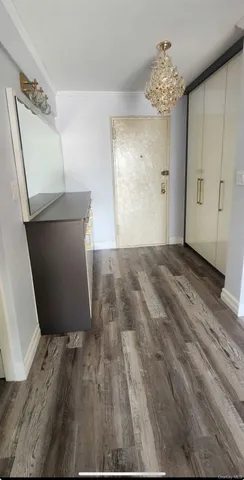 a view of a room with wooden floor and staircase