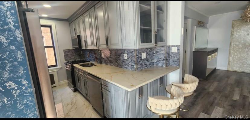 141-60 84th Road, Unit 6A Queens, NY 11435 - Photo 5 of 17 a kitchen with a sink and a refrigerator