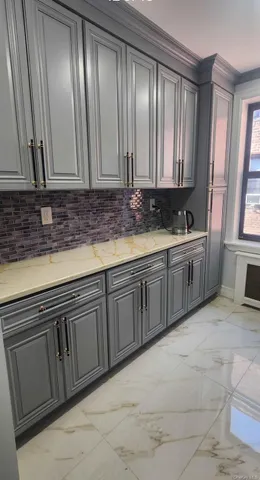 a view of a kitchen with sink and mirror