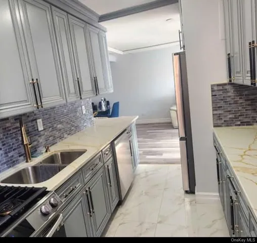 a kitchen with a sink and a refrigerator