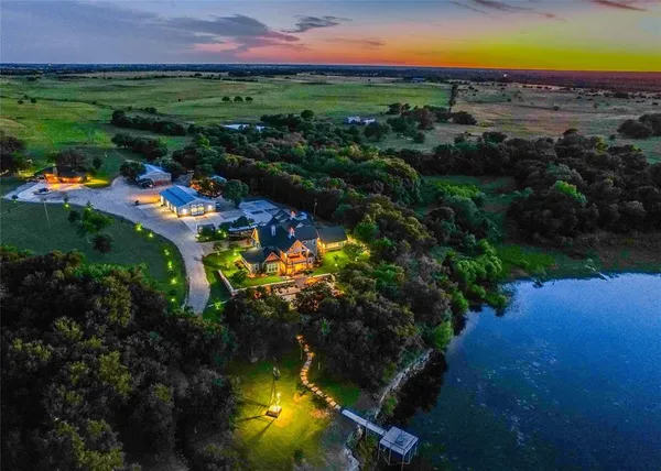 an aerial view of residential houses with outdoor space and swimming pool