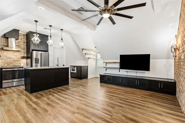 a living room with furniture a flat screen tv and a fireplace