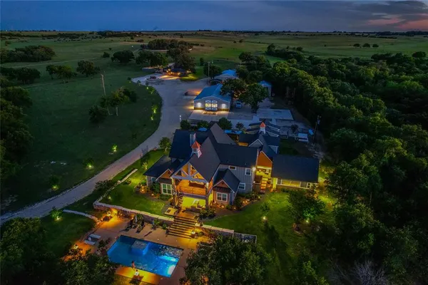 an aerial view of a house with outdoor space pool seating area and yard