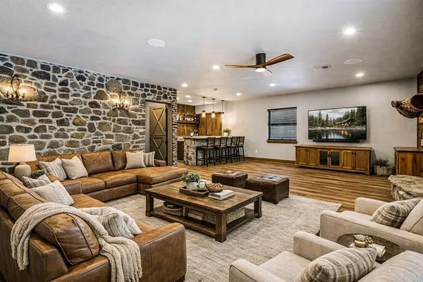an empty room with wooden floor and ceiling fan