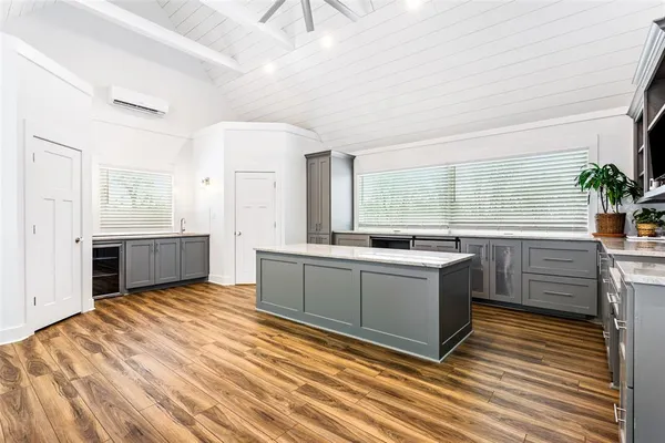 a kitchen with stainless steel appliances granite countertop a refrigerator a stove and a sink