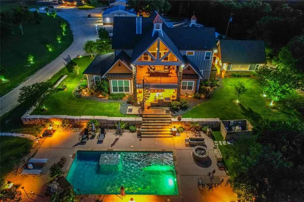 an aerial view of a house with a garden and swimming pool
