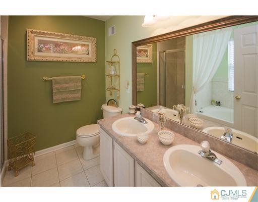 12 Stewart Court Old Bridge, NJ 08857 - Photo 13 of 14 a bathroom with a sink mirror and toilet