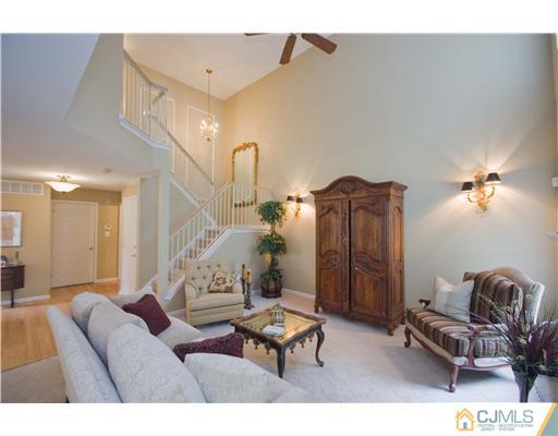 12 Stewart Court Old Bridge, NJ 08857 - Photo 7 of 14 a living room with furniture and a chandelier