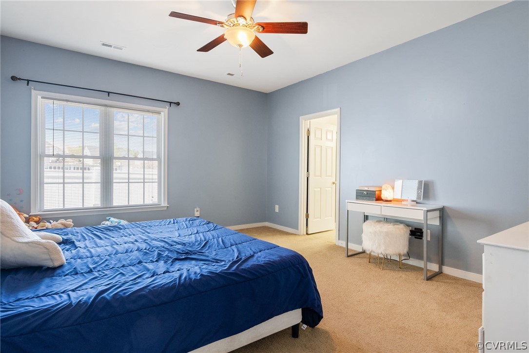 4207 Eagle Drive Hopewell, VA 23860 - Photo 11 of 28 a bedroom with a bed and a chandelier