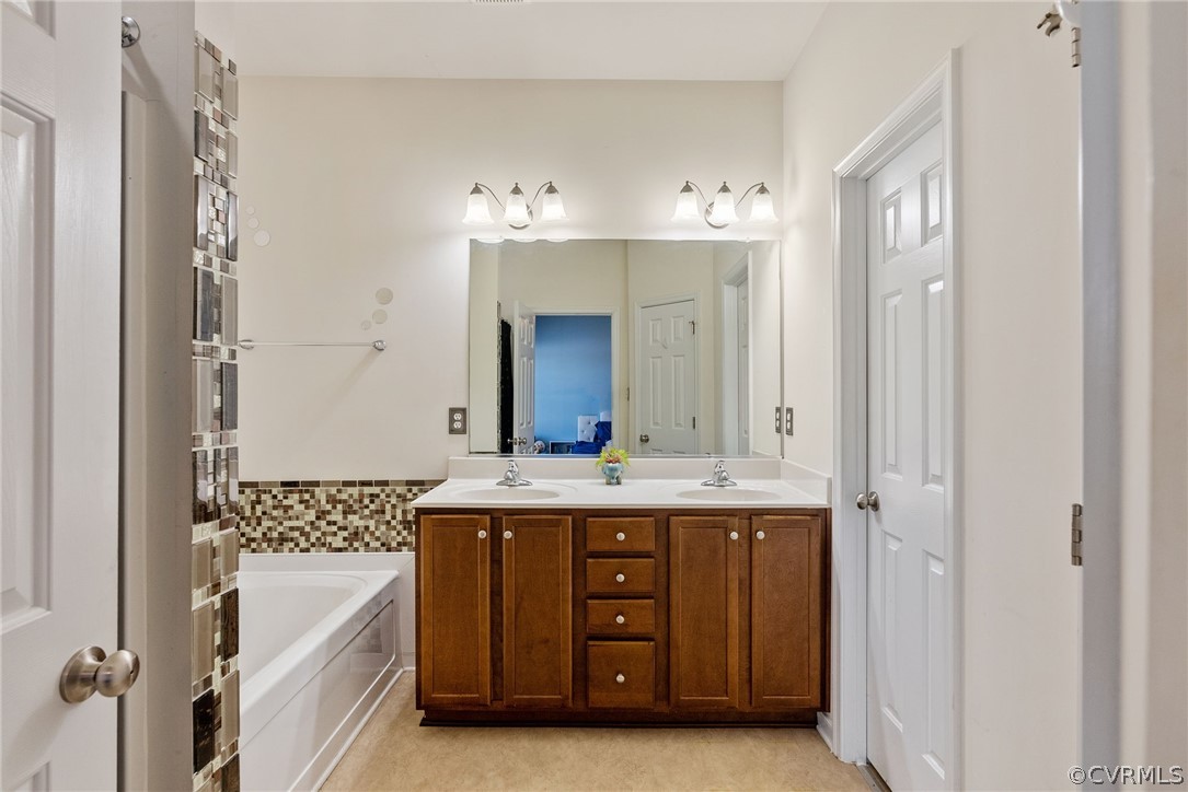 4207 Eagle Drive Hopewell, VA 23860 - Photo 14 of 28 a spacious bathroom with a double vanity sink a mirror a bathtub and a shower
