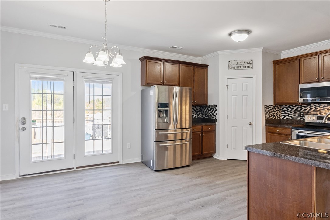 4207 Eagle Drive Hopewell, VA 23860 - Photo 7 of 28 a kitchen with stainless steel appliances wooden floor and a refrigerator