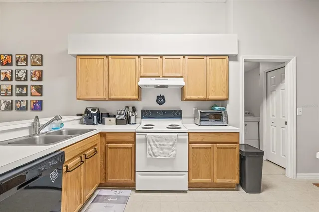 a kitchen with a sink stove and cabinets
