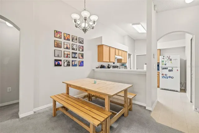 a room with furniture a chandelier and a flat screen tv