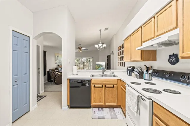 a kitchen with a sink stove and cabinets