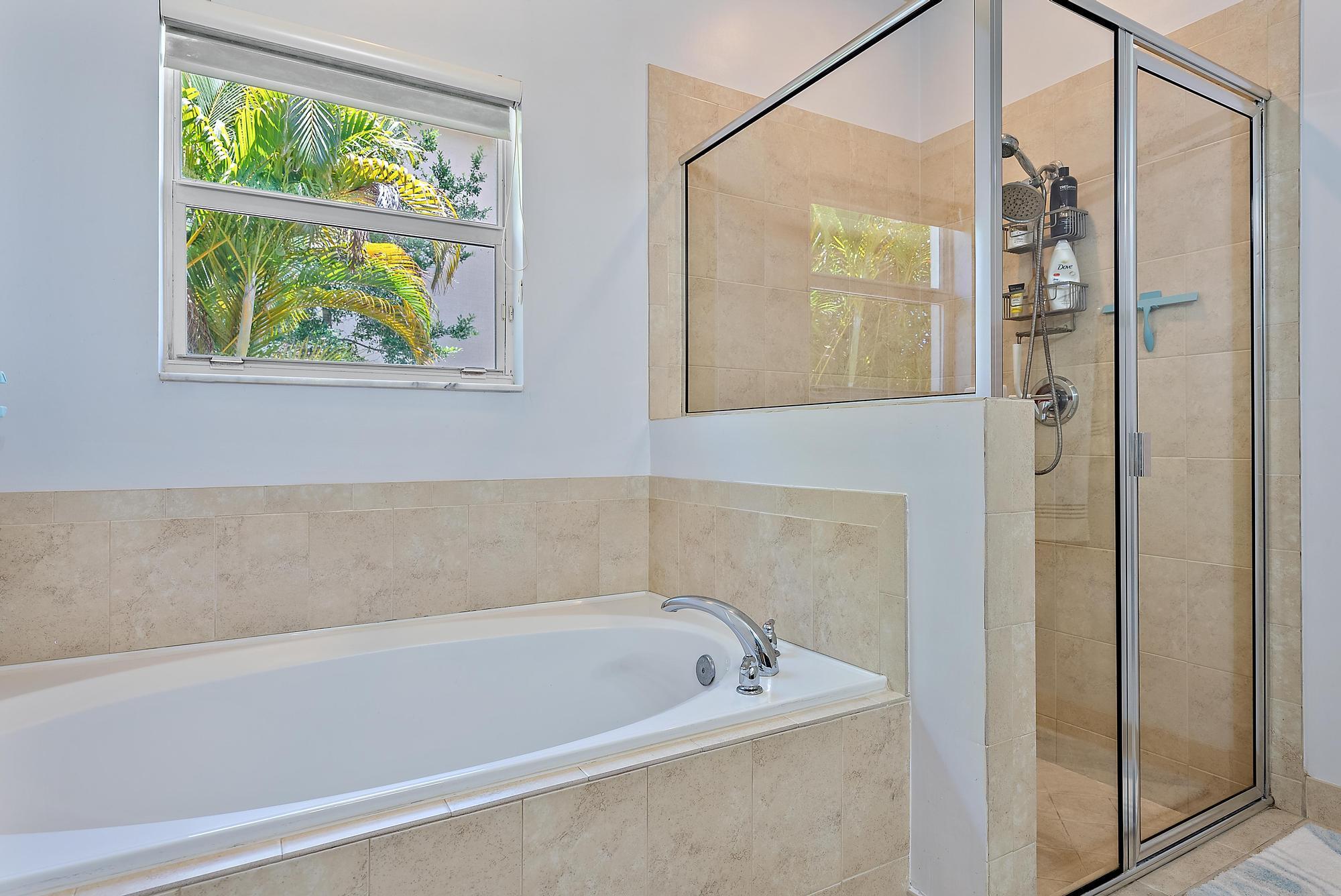 119 Whale Cay Way Jupiter, FL 33458 - Photo 13 of 46 a bathroom with a bathtub and a shower