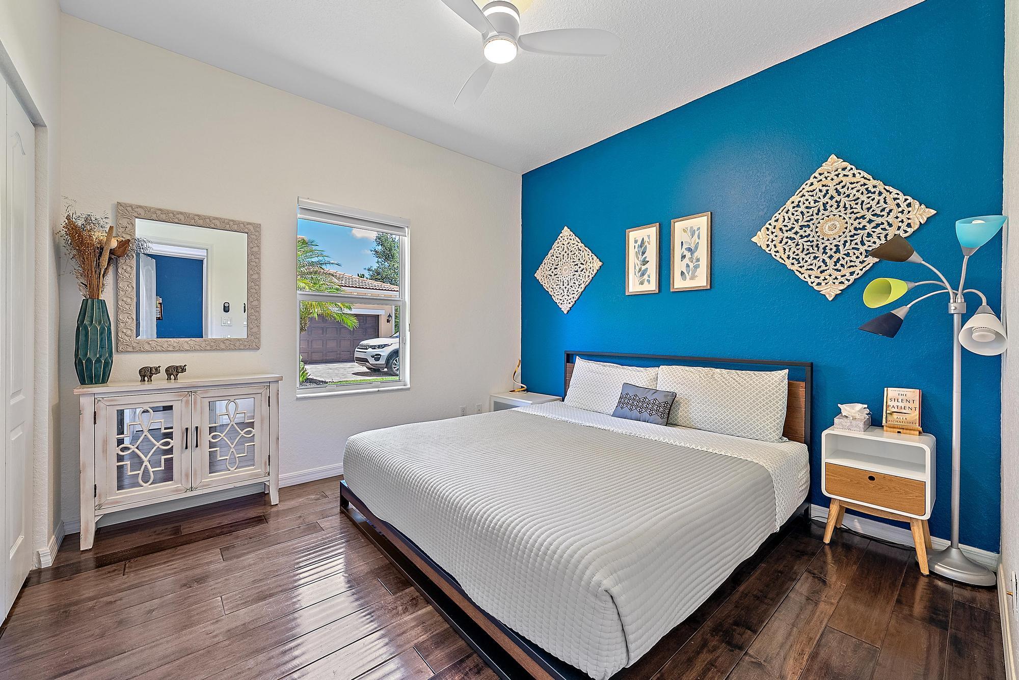 119 Whale Cay Way Jupiter, FL 33458 - Photo 14 of 46 a bedroom with a bed and a dresser