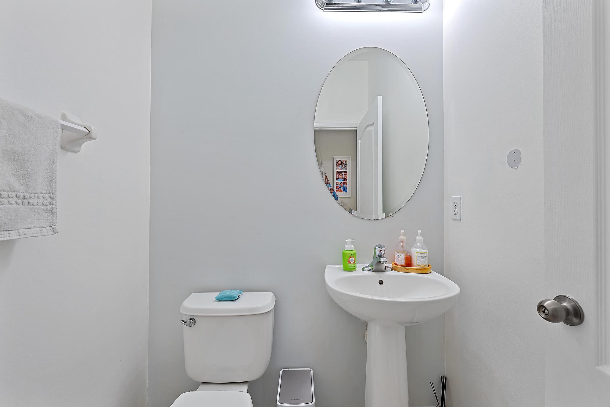 119 Whale Cay Way Jupiter, FL 33458 - Photo 20 of 46 a bathroom with a toilet a sink and a mirror