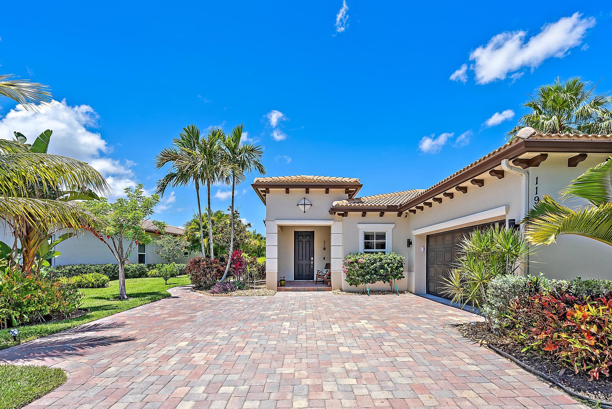 119 Whale Cay Way Jupiter, FL 33458 - Photo 23 of 46 a front view of a house with a yard