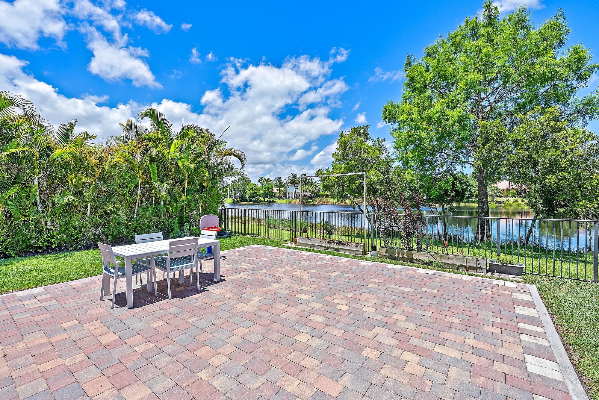 119 Whale Cay Way Jupiter, FL 33458 - Photo 25 of 46 a view of a backyard with sitting area