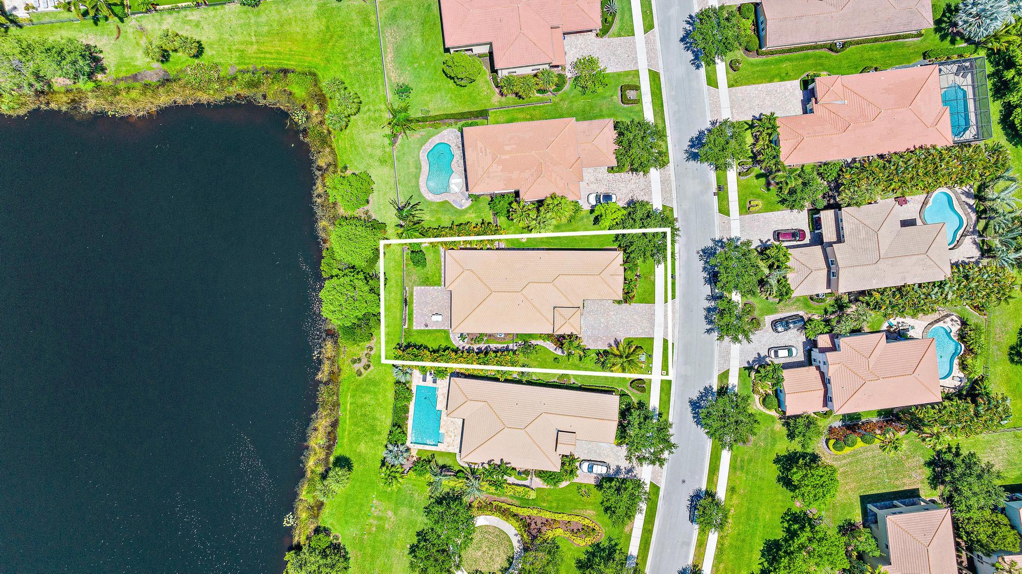 119 Whale Cay Way Jupiter, FL 33458 - Photo 29 of 46 an aerial view of a house with a yard and green space
