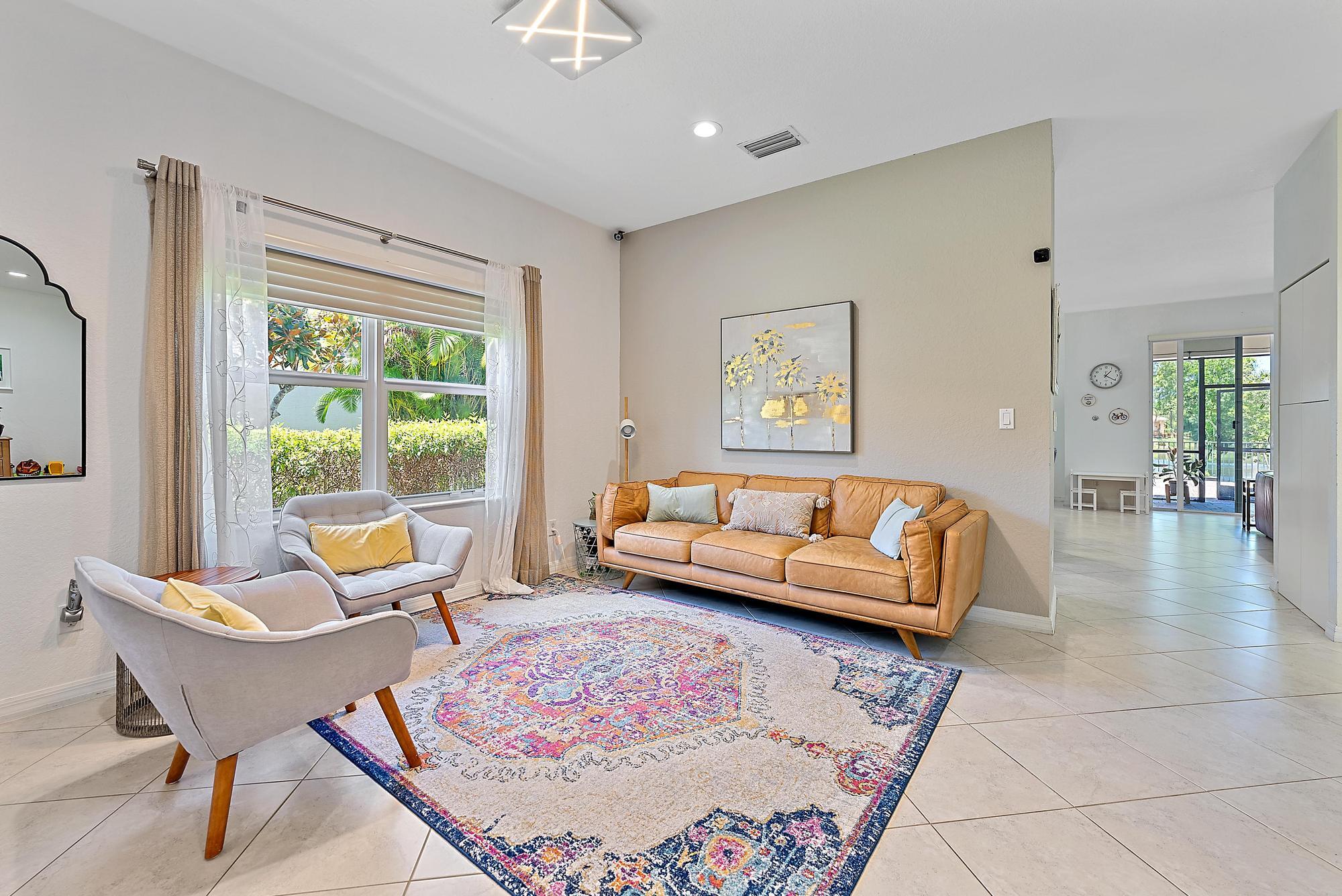 119 Whale Cay Way Jupiter, FL 33458 - Photo 5 of 46 a living room with furniture and a large window