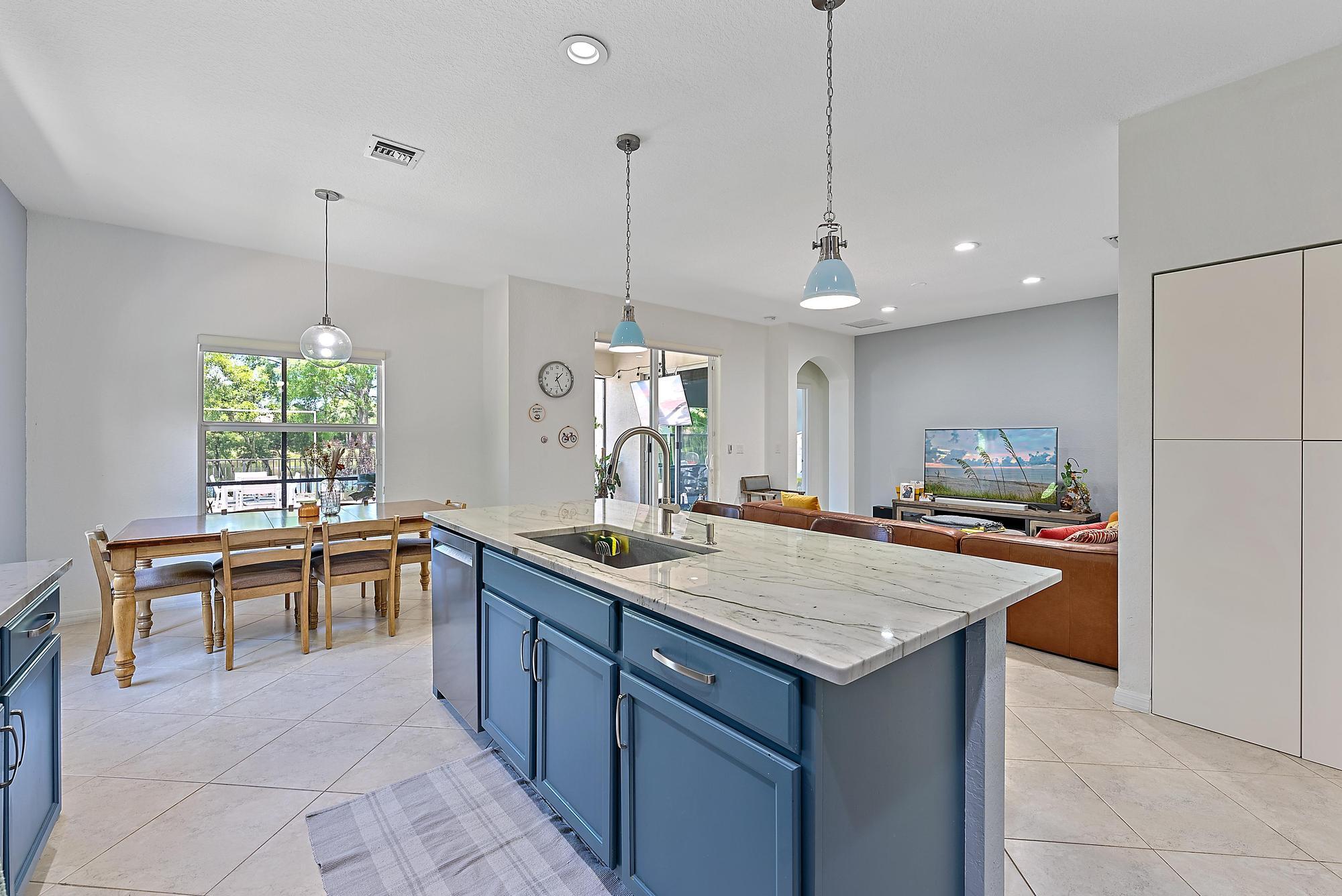 119 Whale Cay Way Jupiter, FL 33458 - Photo 7 of 46 a kitchen with a stove a refrigerator a sink and chairs
