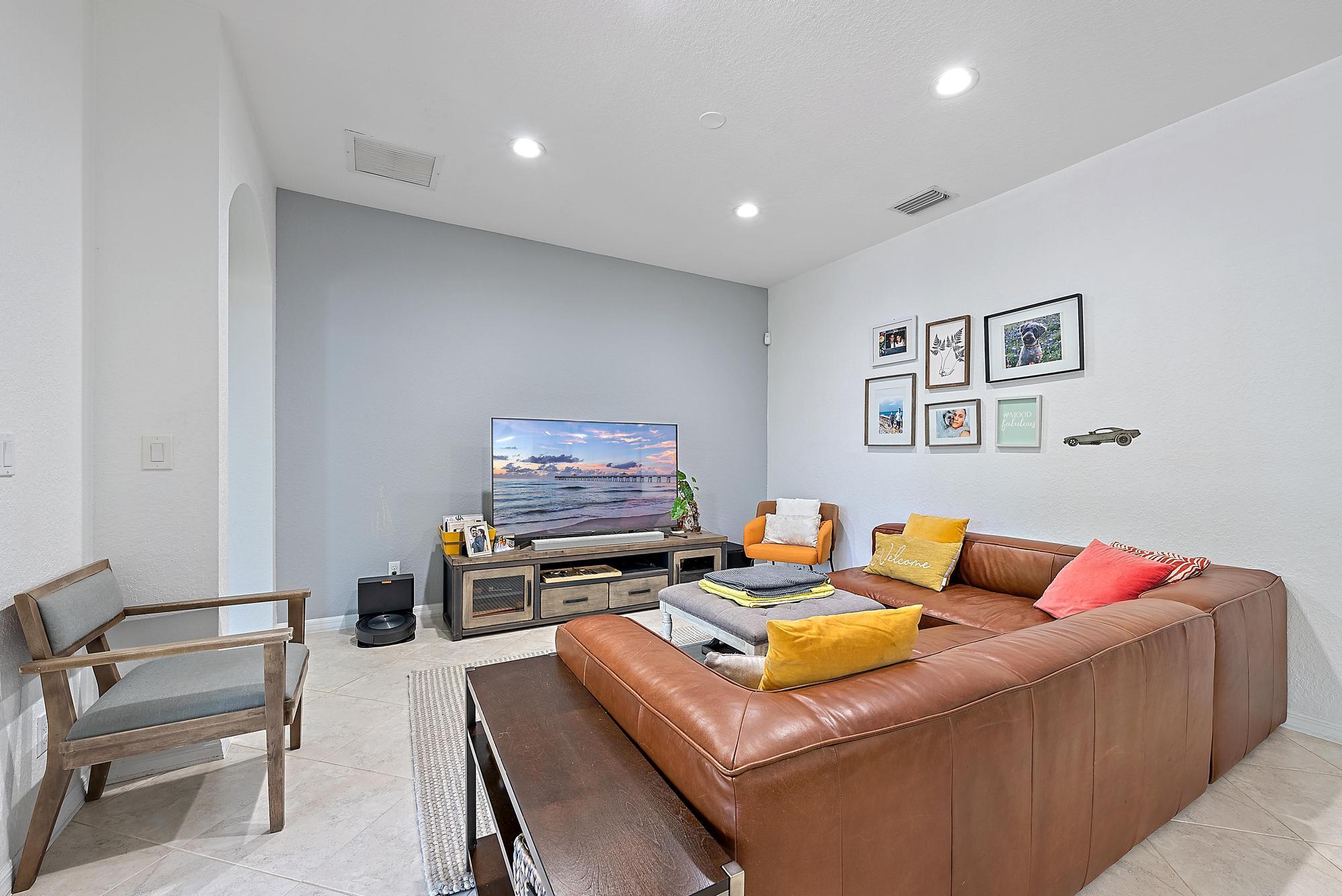 119 Whale Cay Way Jupiter, FL 33458 - Photo 8 of 46 a living room with furniture and a flat screen tv