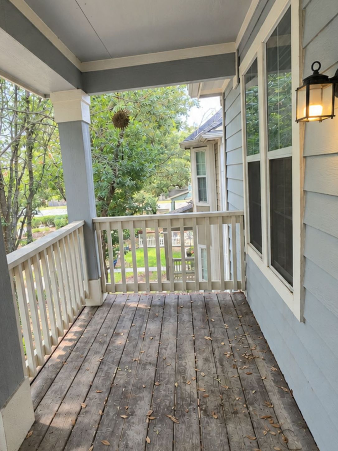 5679 Fergus, Unit B Kyle, TX 78640 - Photo 24 of 26 A covered wooden deck features clean railings and looks out over the surrounding neighborhood trees.