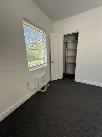 a view of a room that has a bed in it