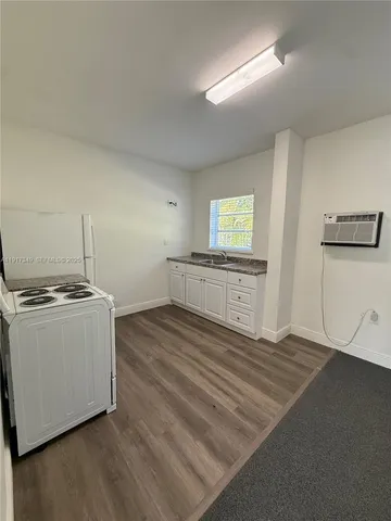 a view of a kitchen with a sink dishwasher and a refrigerator