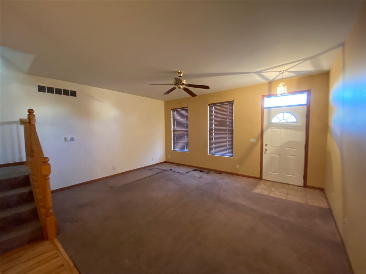 225 Market Street Genoa, IL 60135 - Photo 4 of 13 a view of a livingroom with wooden floor and a ceiling fan