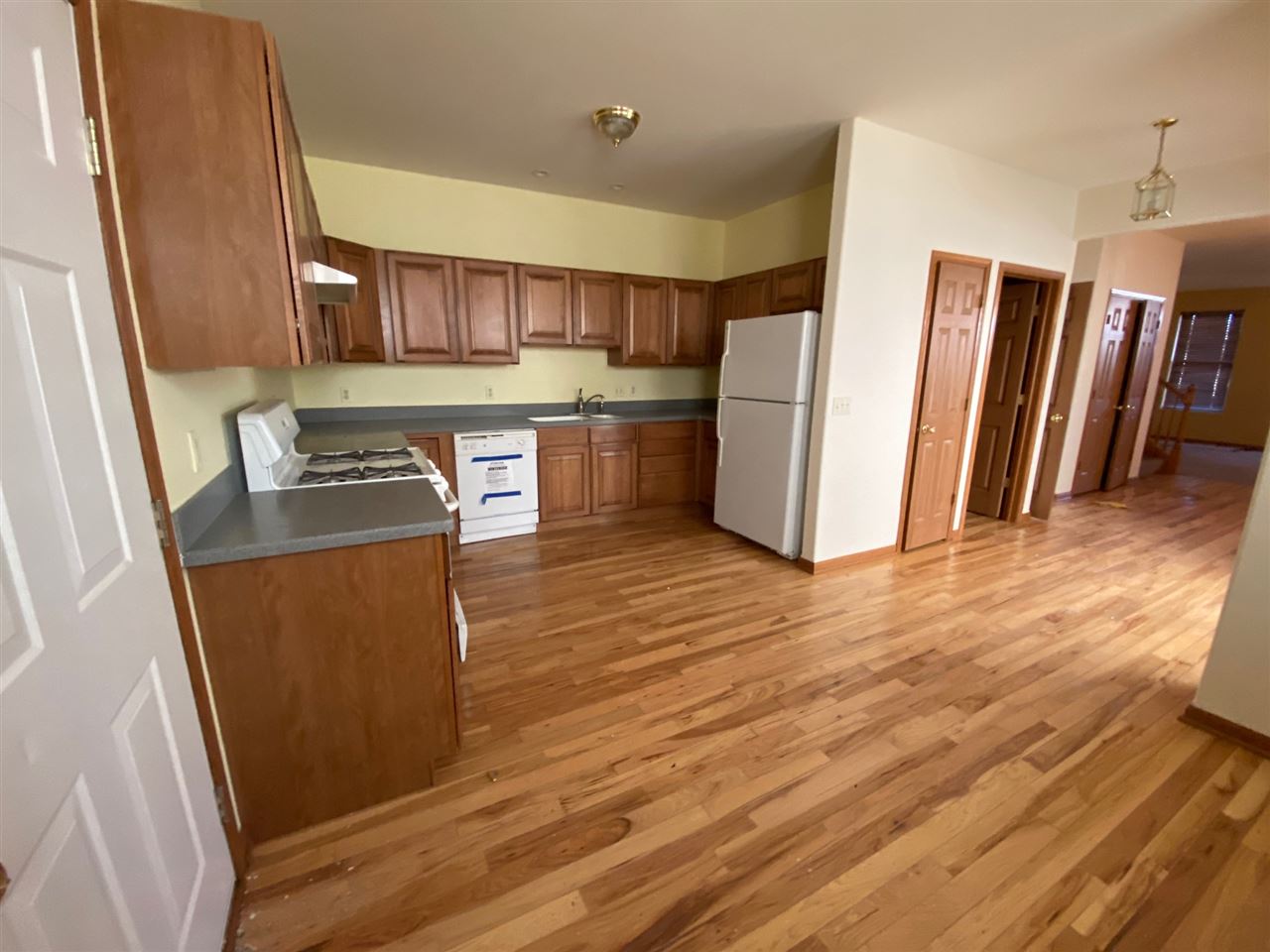 225 Market Street Genoa, IL 60135 - Photo 7 of 13 a kitchen with stainless steel appliances a refrigerator a sink a stove a microwave and wooden floors